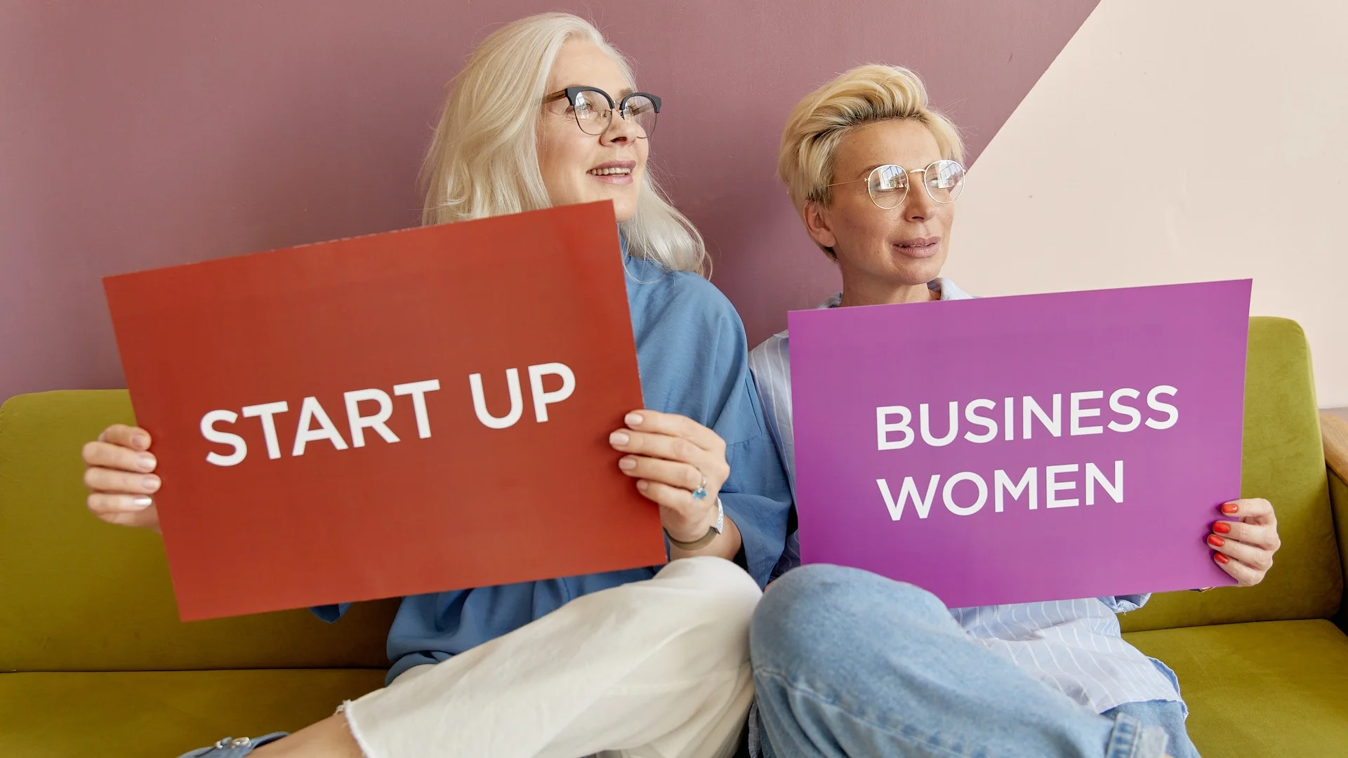 two women holding startup business women signs